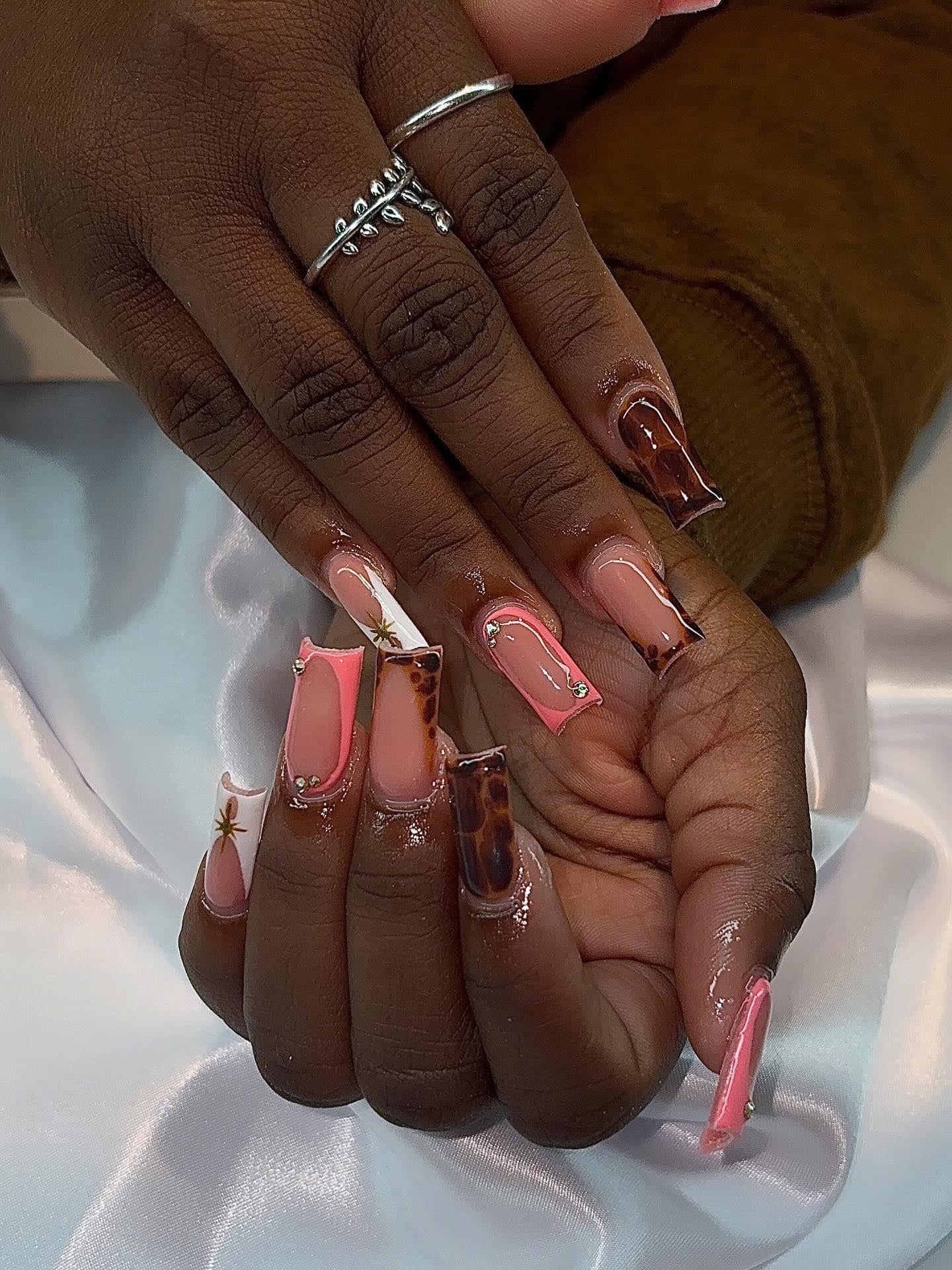 Long square set mixing coral French tips, tortoiseshell nails and small gold star charms.