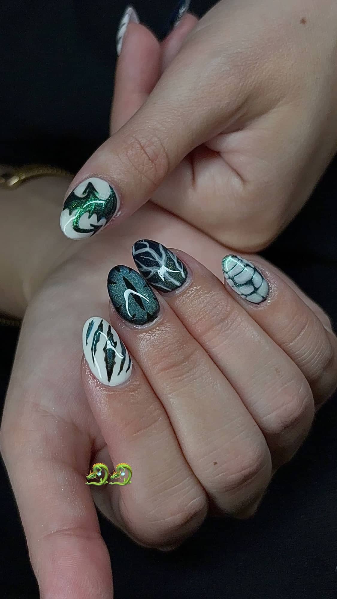Almond set with hand-painted green and white dragon designs, dragon-scale detailing and a green cat-eye nail.