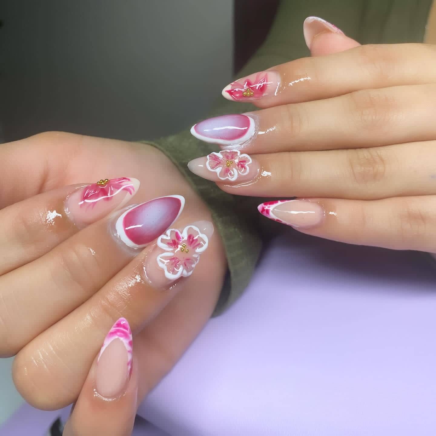Almond set with hand-painted pink flowers, blush aura gradients and white 3D blossoms.