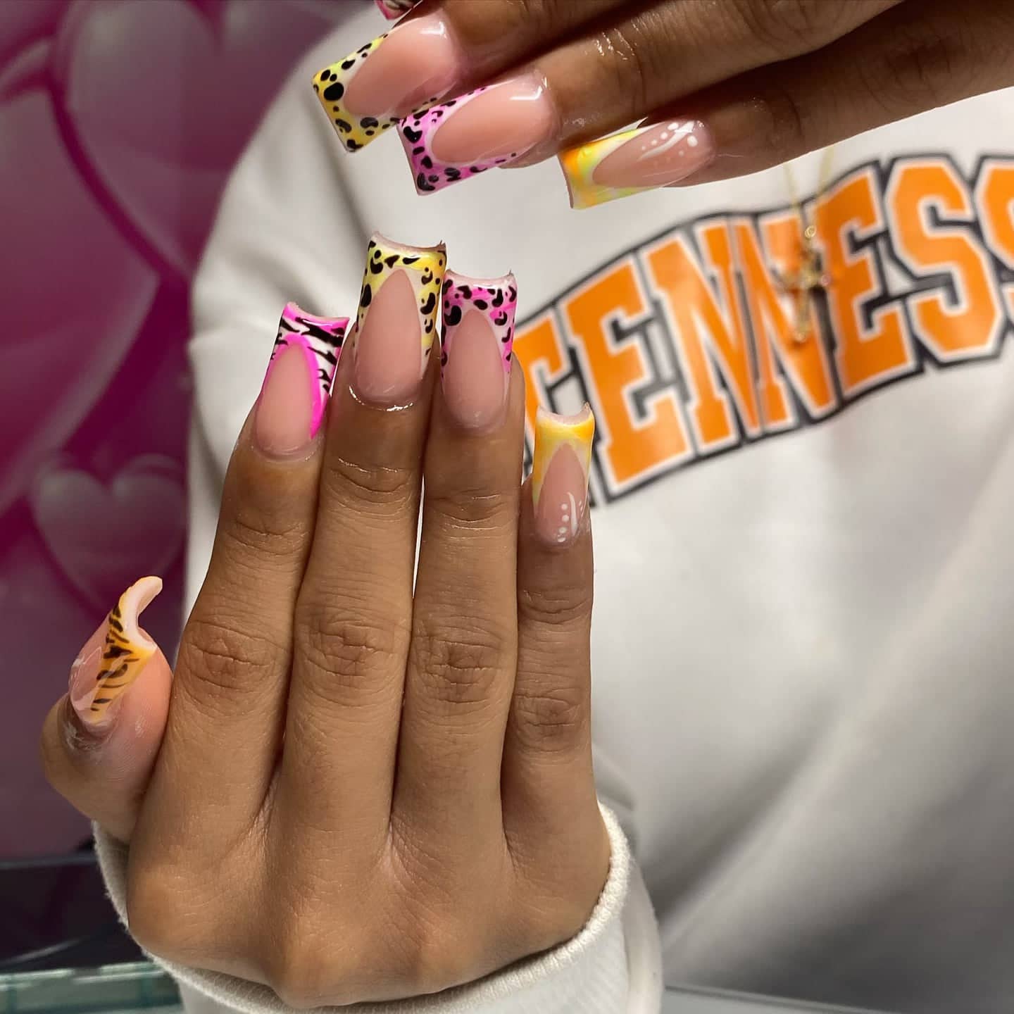 Square French tips in hot pink and yellow with zebra stripes and leopard spots.