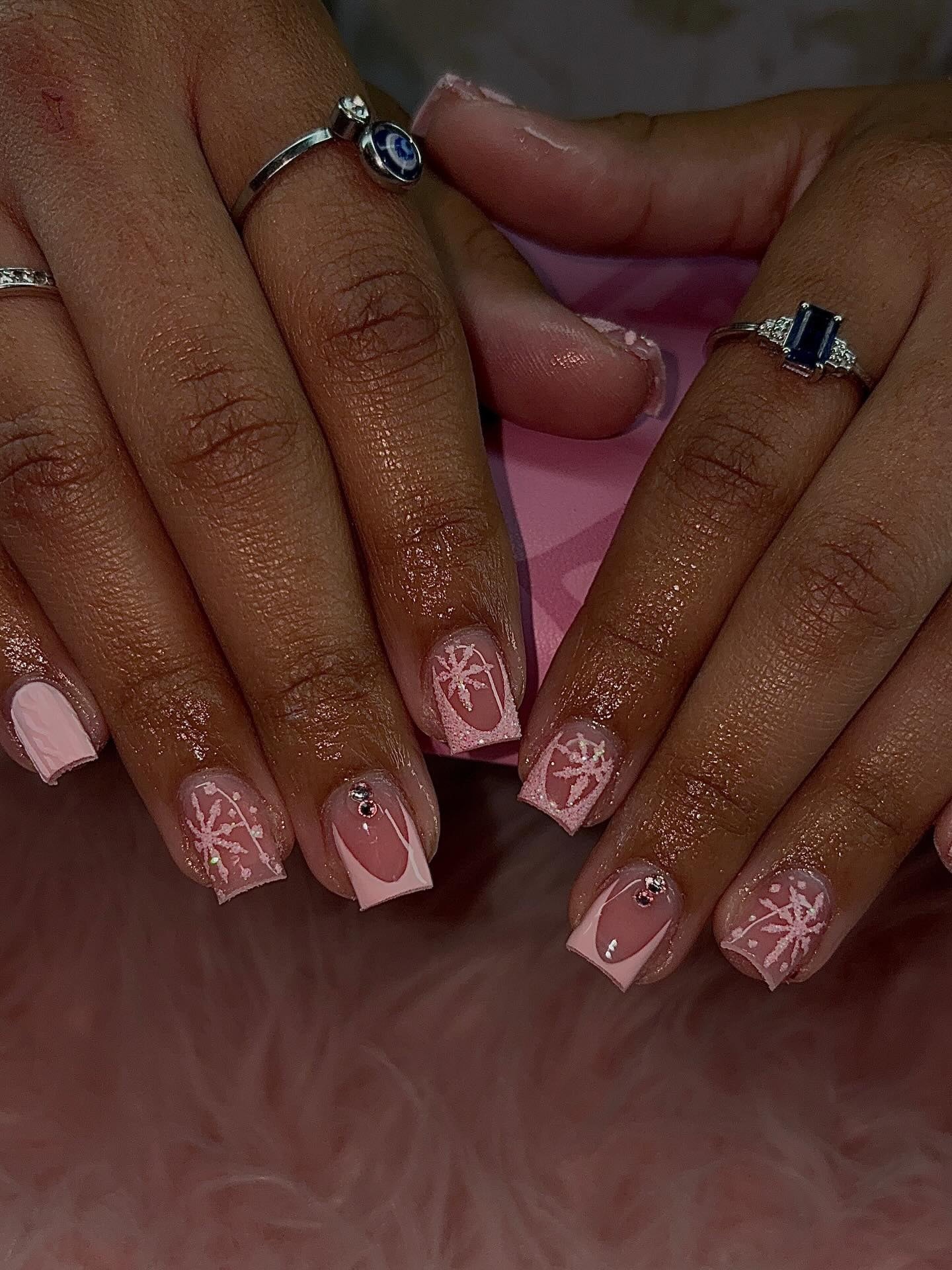 Short square winter set with pink French tips, hand-painted white snowflakes and rhinestones.