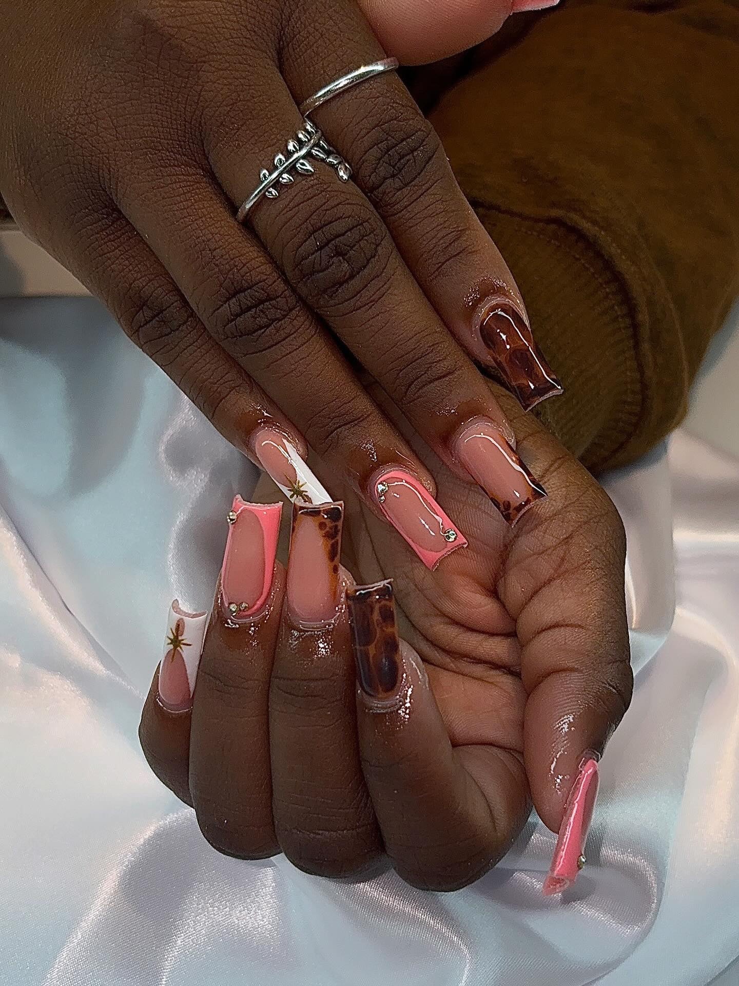 Long square set mixing coral French tips, tortoiseshell nails and small gold star charms.