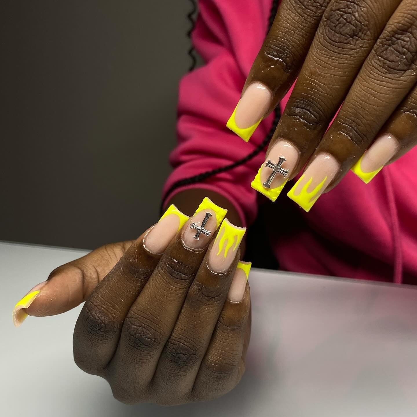 Square set with neon-yellow French tips, flame details and silver cross charms.