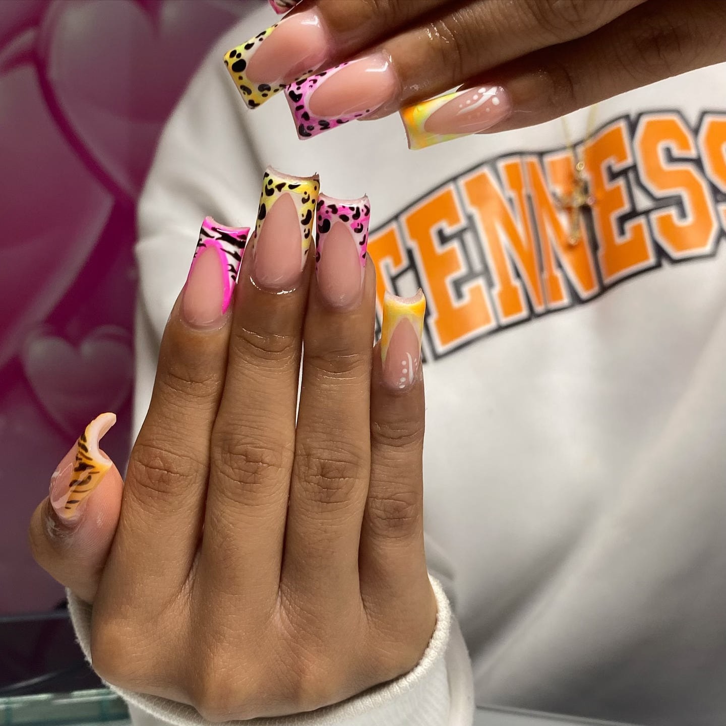 Square French tips in hot pink and yellow with zebra stripes and leopard spots.